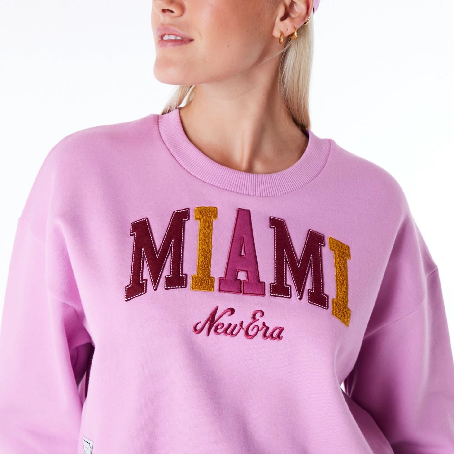 The Female model is wearing New Era Infill Pastel Pink Crop Crew Neck Sweatshirt 7