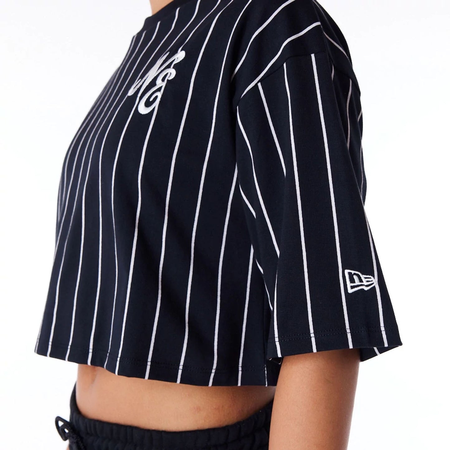 The Female model is wearing New Era Womens Pinstripe Black Crop T-Shirt 3