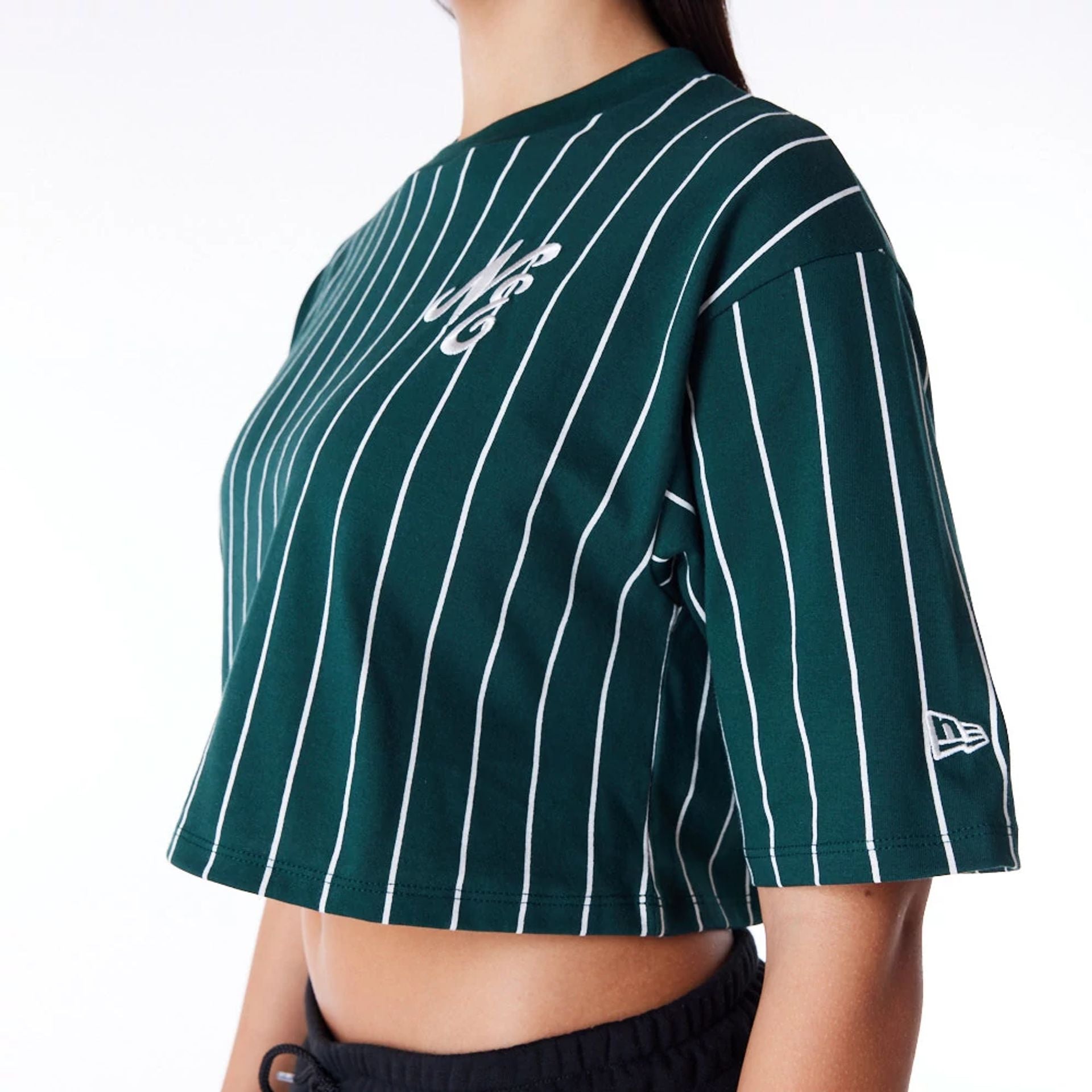 The Female model is wearing New Era Womens Pinstripe Dark Green Crop T-Shirt 3