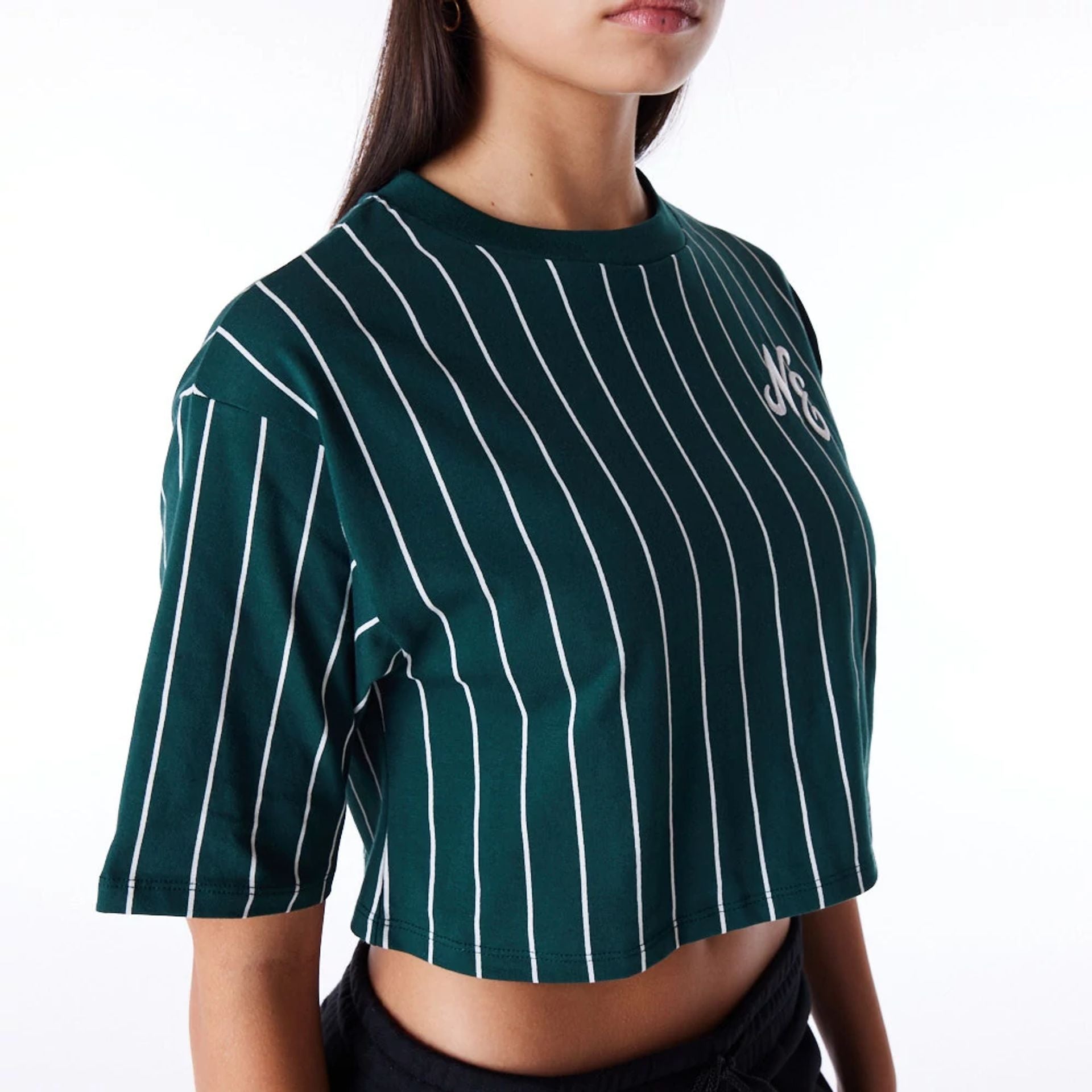 The Female model is wearing New Era Womens Pinstripe Dark Green Crop T-Shirt 6