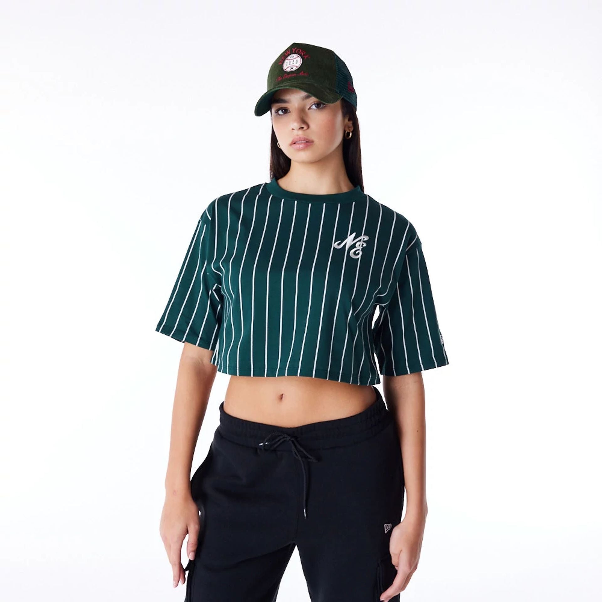 The Female model is wearing New Era Womens Pinstripe Dark Green Crop T-Shirt 1