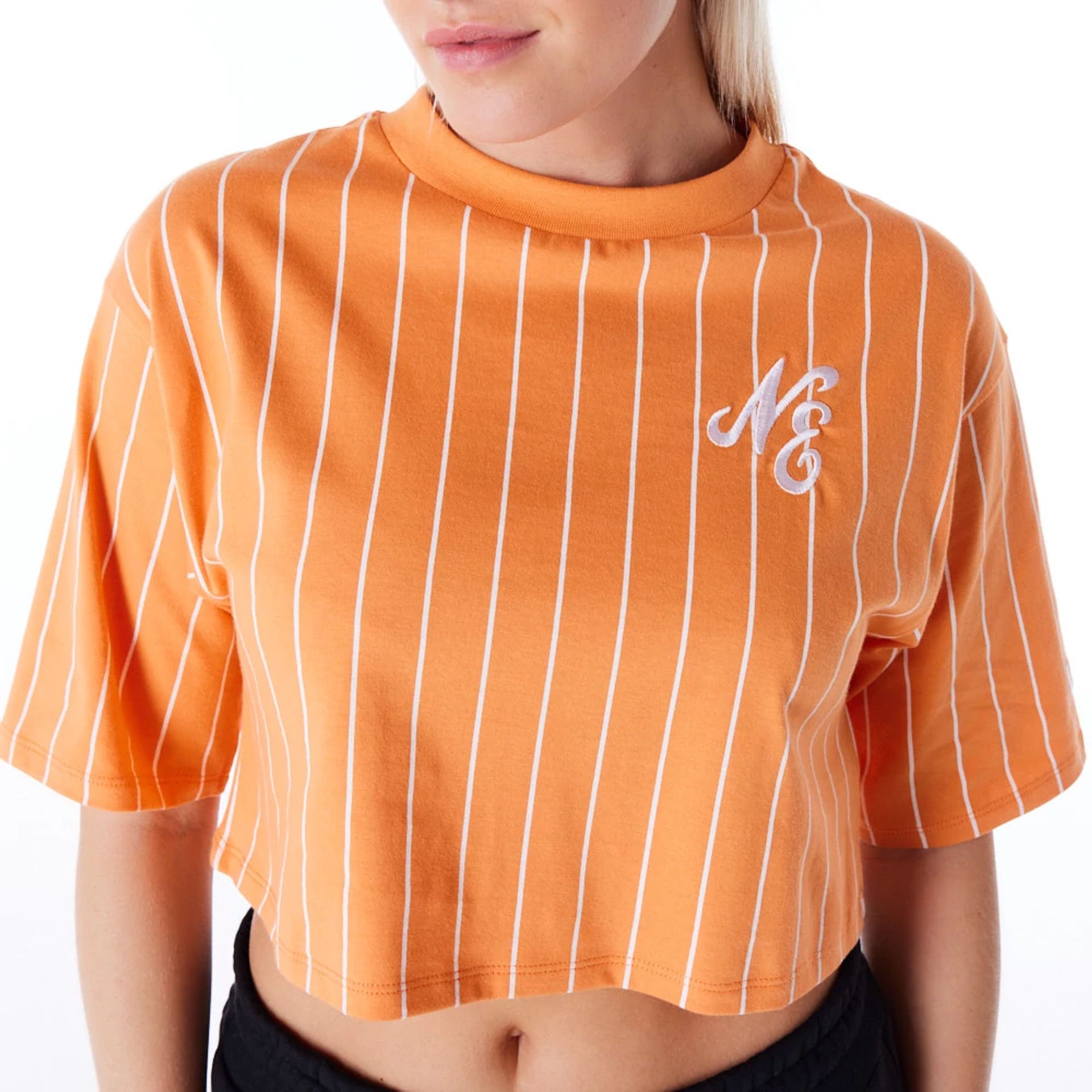 The Female model is wearing New Era Womens Pinstripe Orange Crop T-Shirt 5