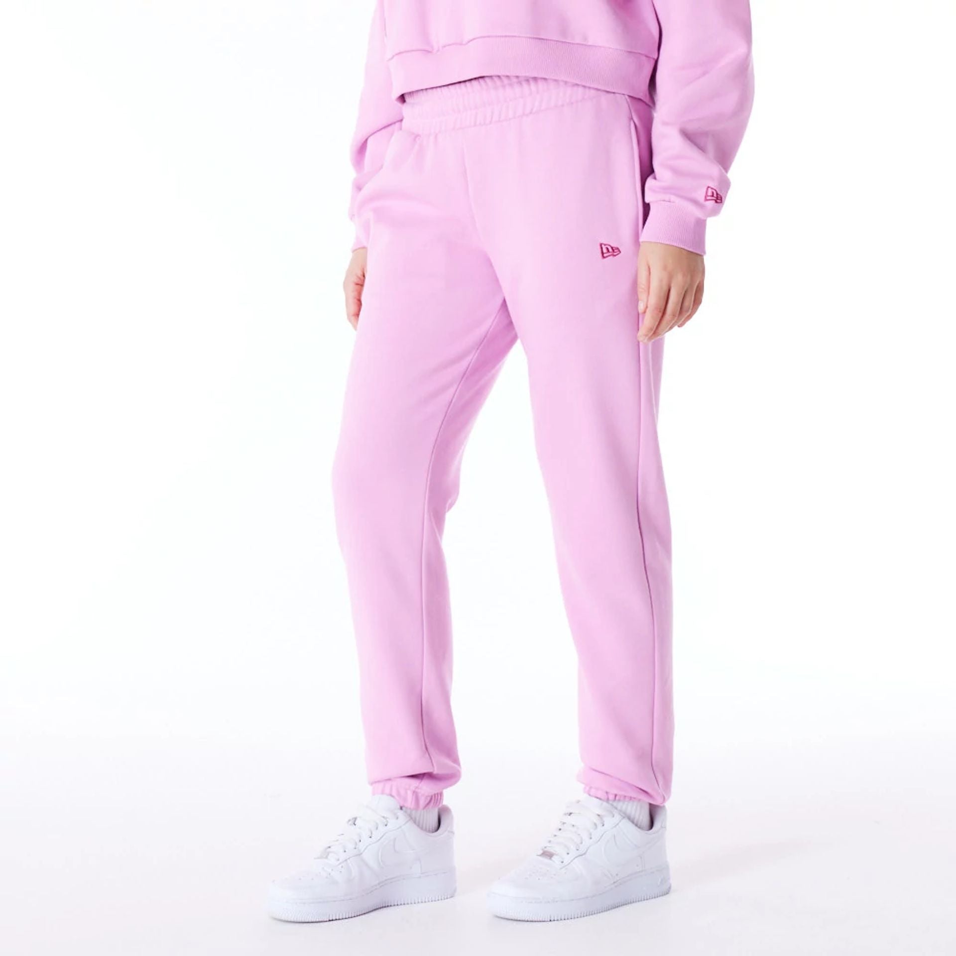 The Female model is wearing New Era Infill Pastel Pink Fleece Joggers 1