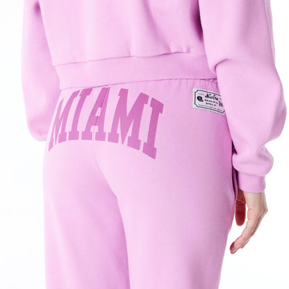 The Female model is wearing New Era Infill Pastel Pink Fleece Joggers 9