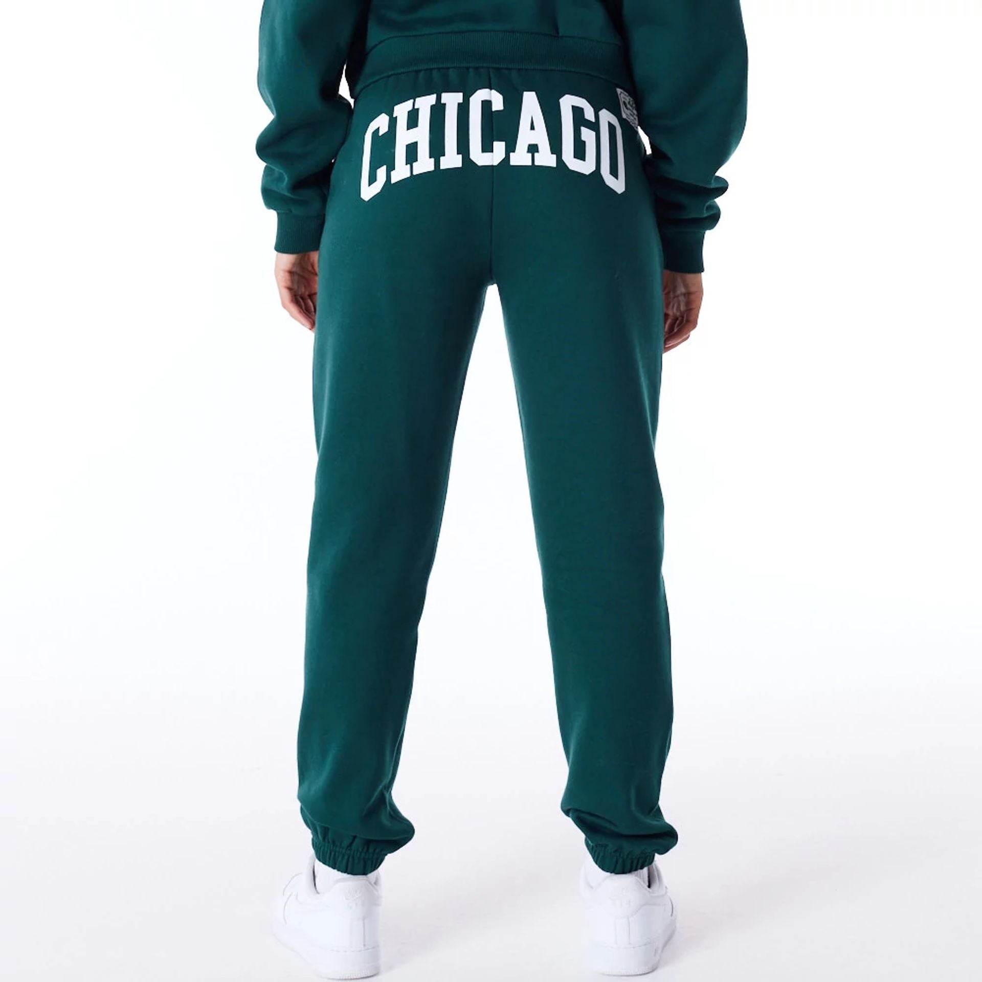 The Female model is wearing New Era Infill Dark Green Fleece Joggers 2