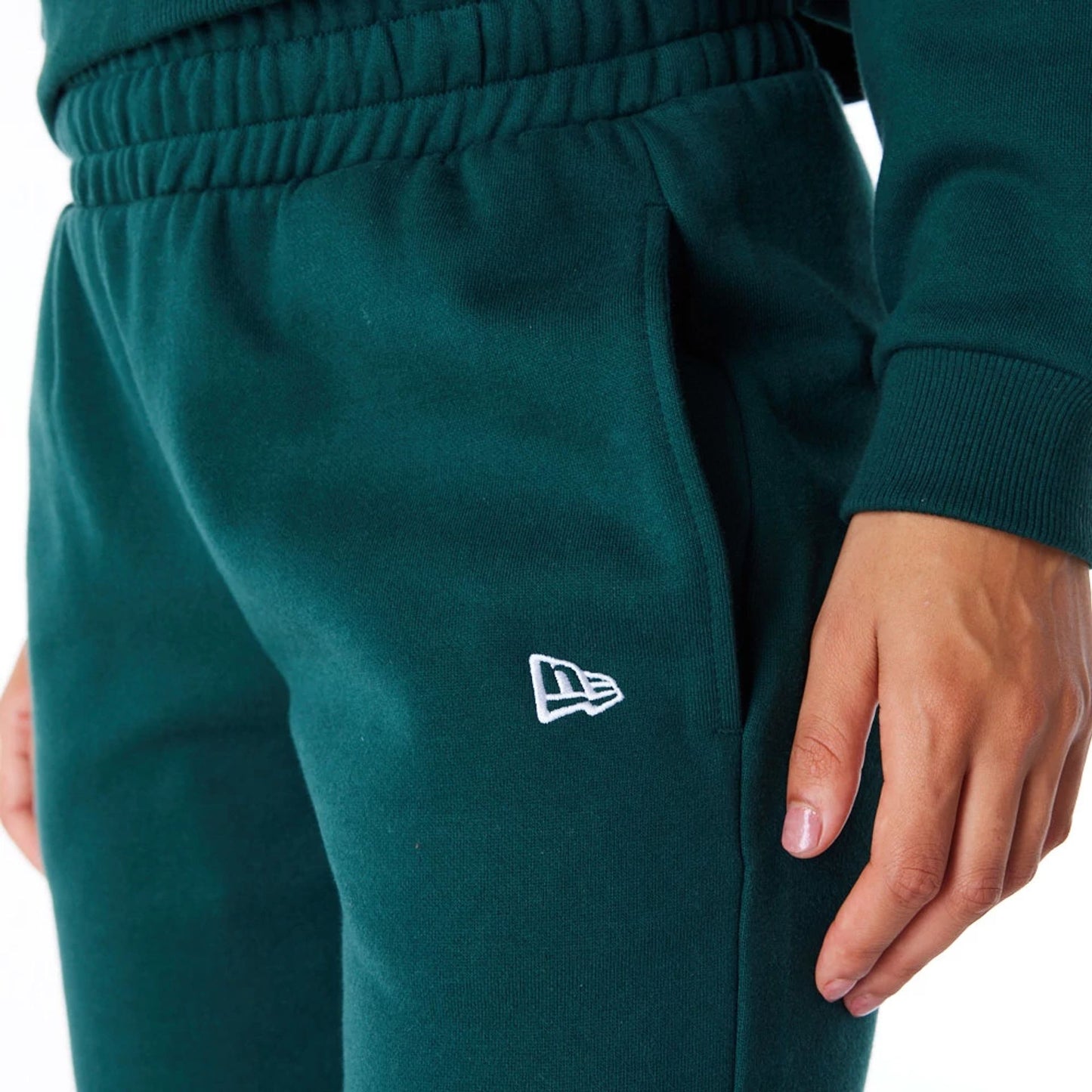 The Female model is wearing New Era Infill Dark Green Fleece Joggers 8