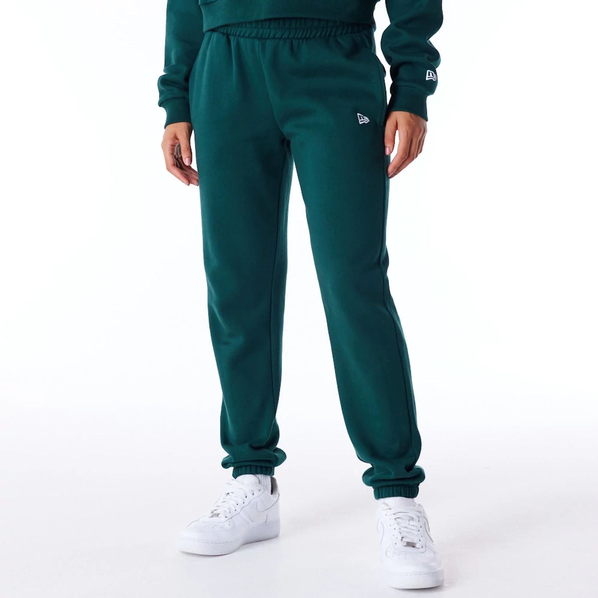 The Female model is wearing New Era Infill Dark Green Fleece Joggers 1