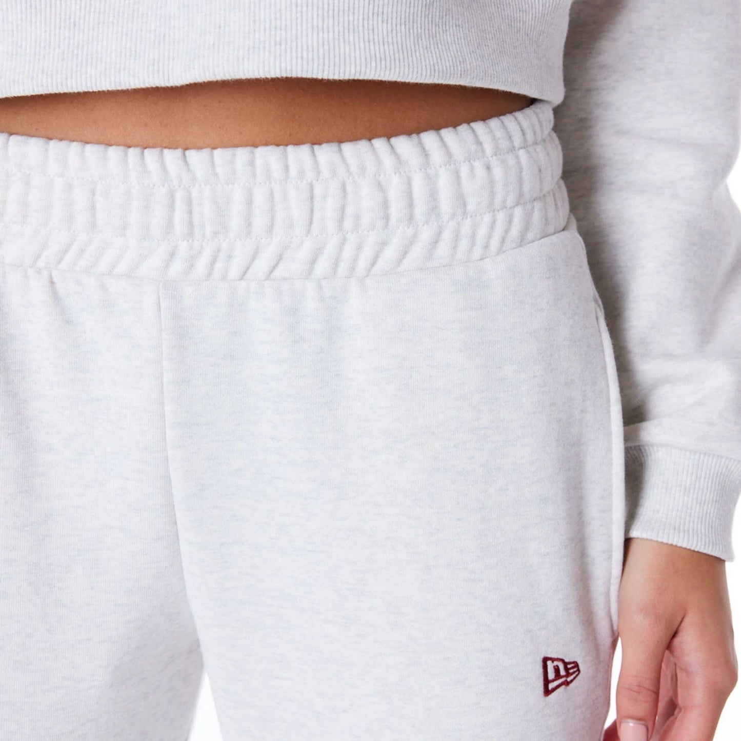 The Female model is wearing New Era Infill Grey Fleece Joggers 6