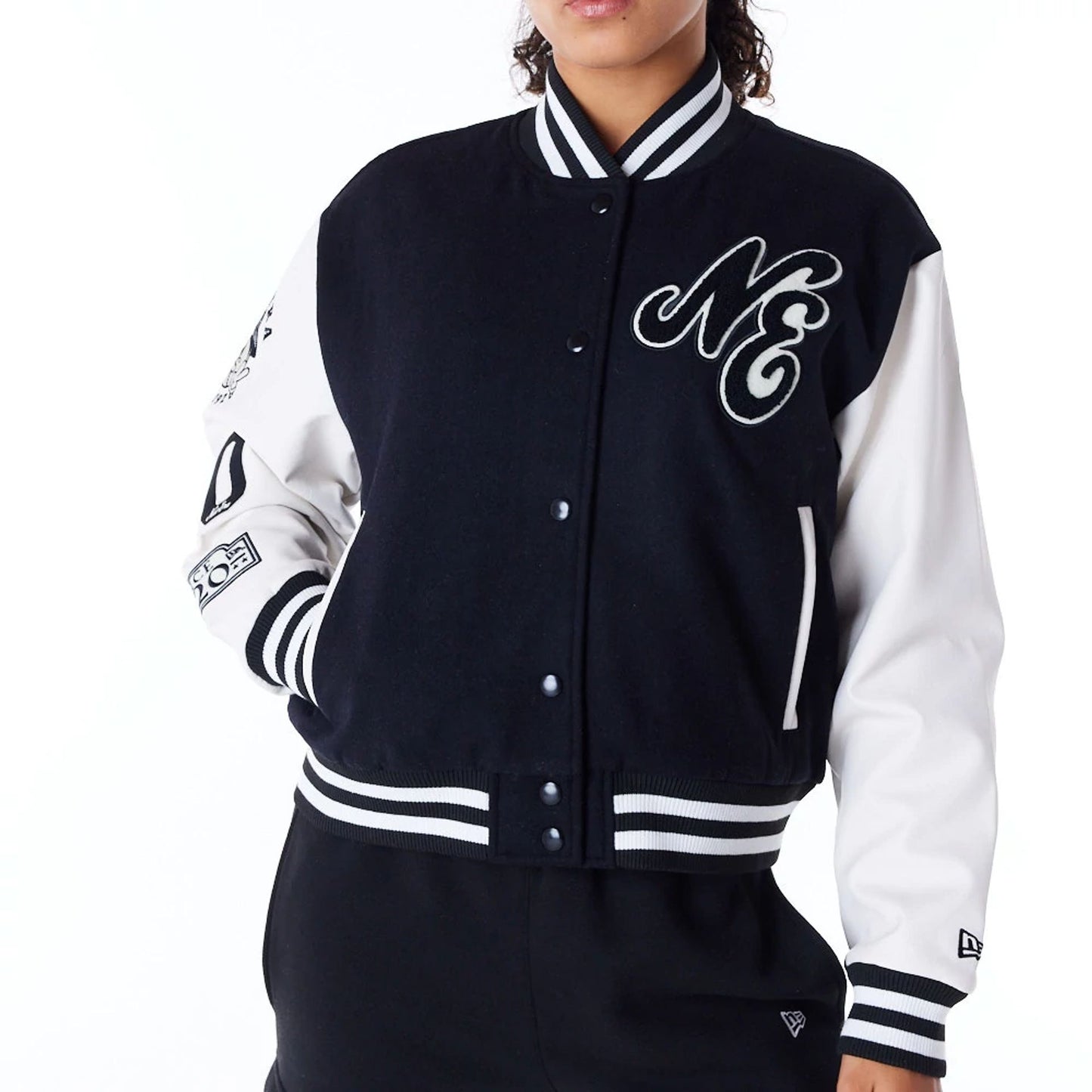 The Female model is wearing New Era Womens Black Varsity Jacket 7