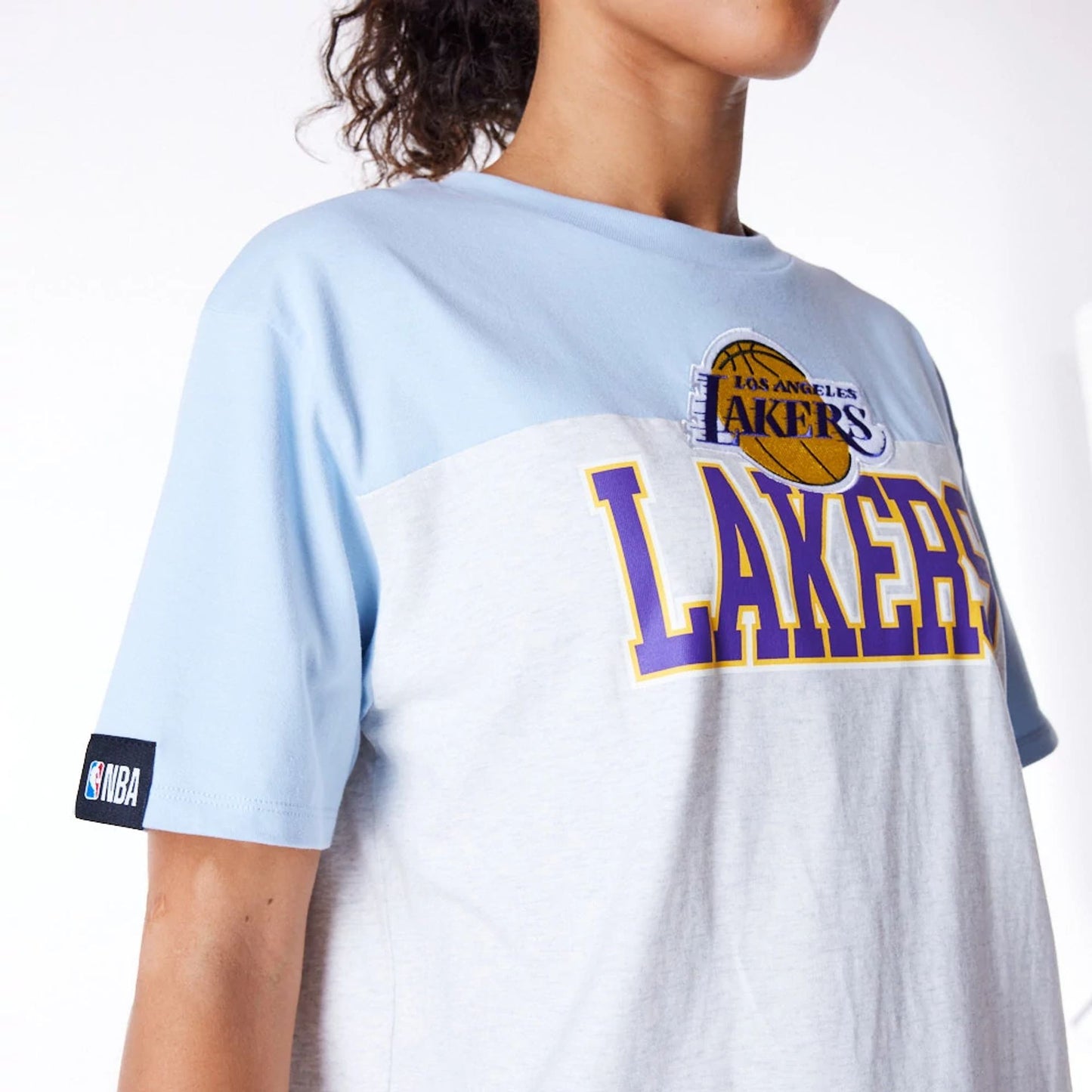 The Female model is wearing LA Lakers Womens NBA Pastel Blue Oversized T-Shirt 3