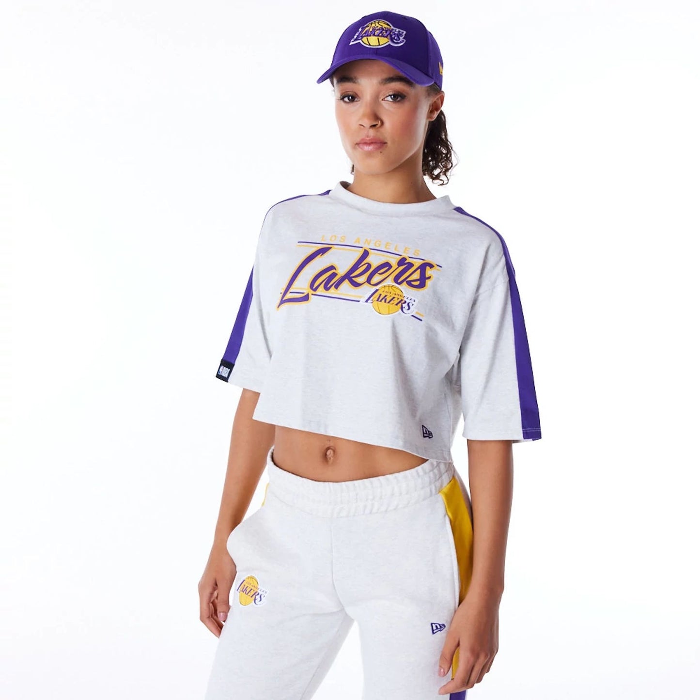 The Female model is wearing LA Lakers Womens NBA Colour Block Grey Crop T-Shirt 1