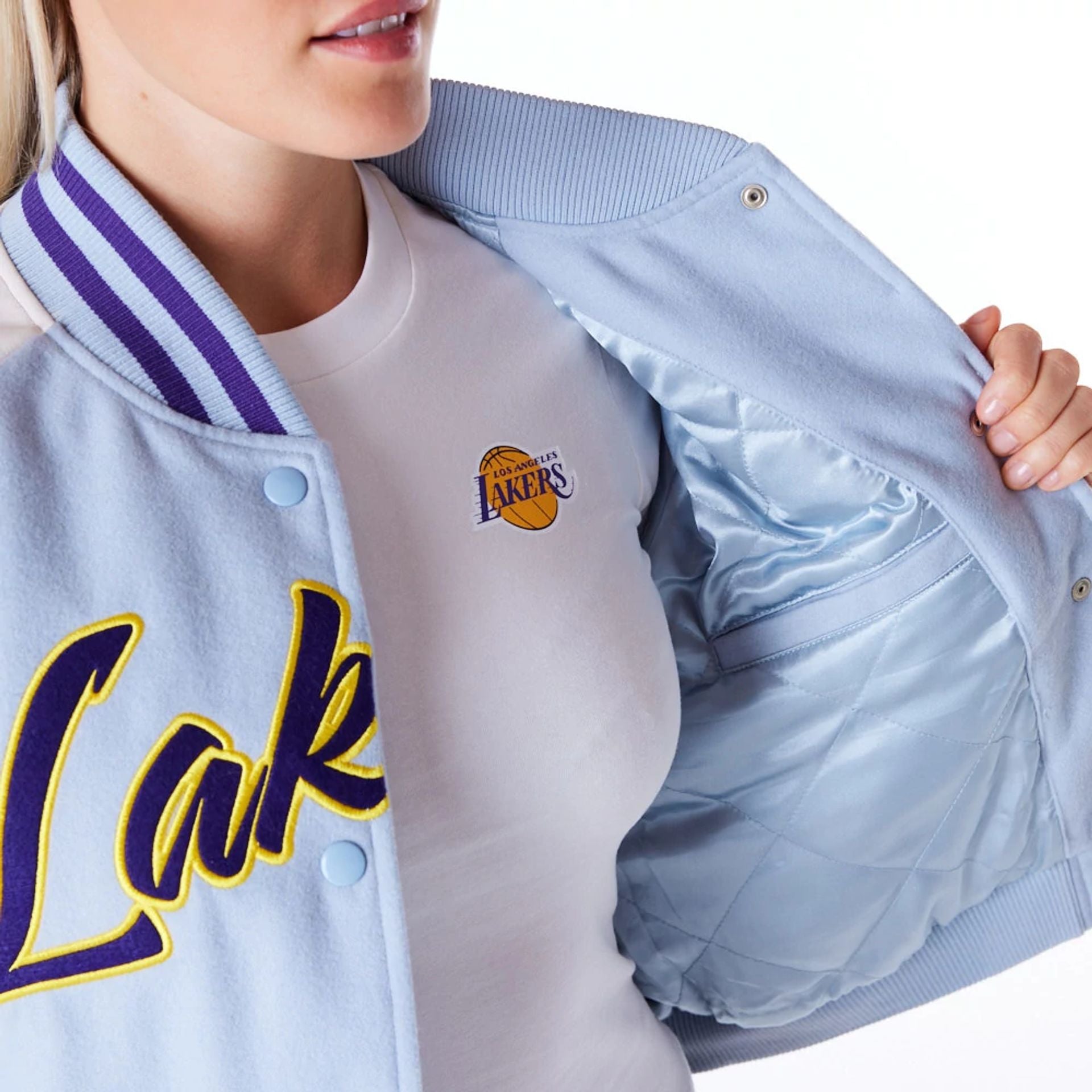 The Female model is wearing LA Lakers Womens NBA Pastel Blue Varsity Jacket 2