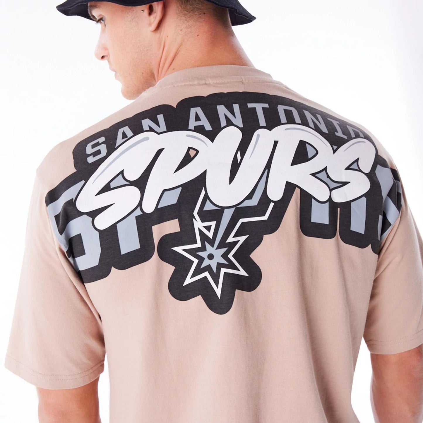 The Male model is wearing San Antonio Spurs NBA Wordmark Beige Oversized T-Shirt 2