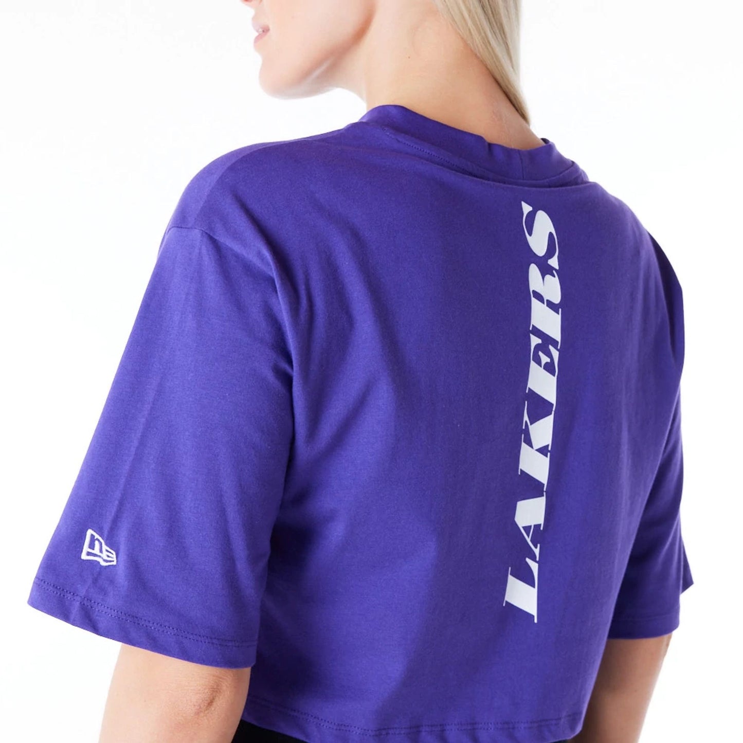 The Female model is wearing LA Lakers Womens NBA Team Logo Wordmark Purple Crop T-Shirt 7