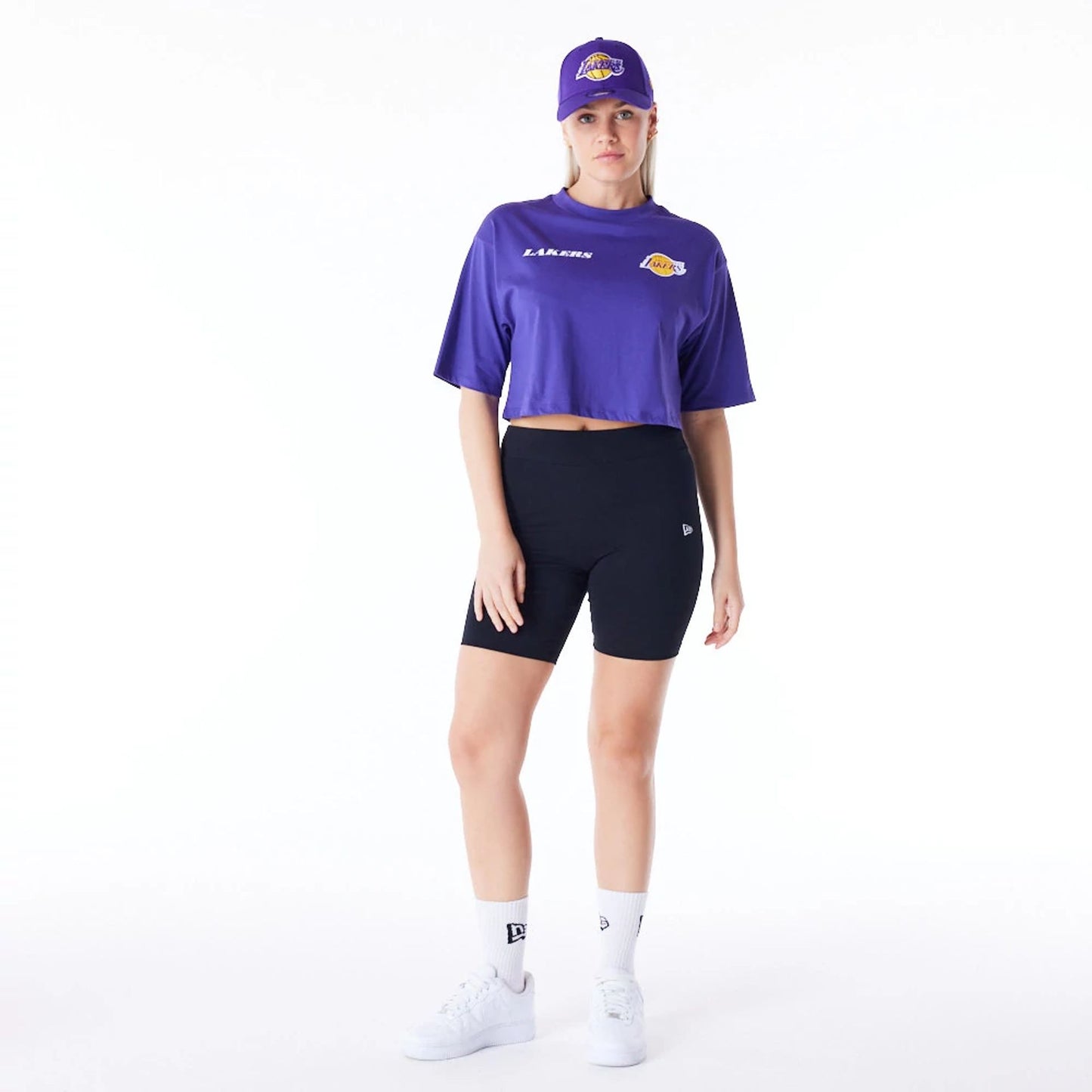 The Female model is wearing LA Lakers Womens NBA Team Logo Wordmark Purple Crop T-Shirt 4