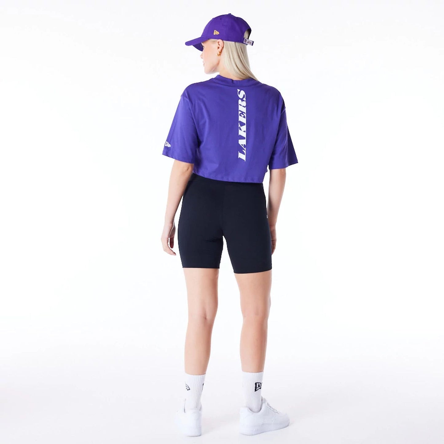 The Female model is wearing LA Lakers Womens NBA Team Logo Wordmark Purple Crop T-Shirt 5