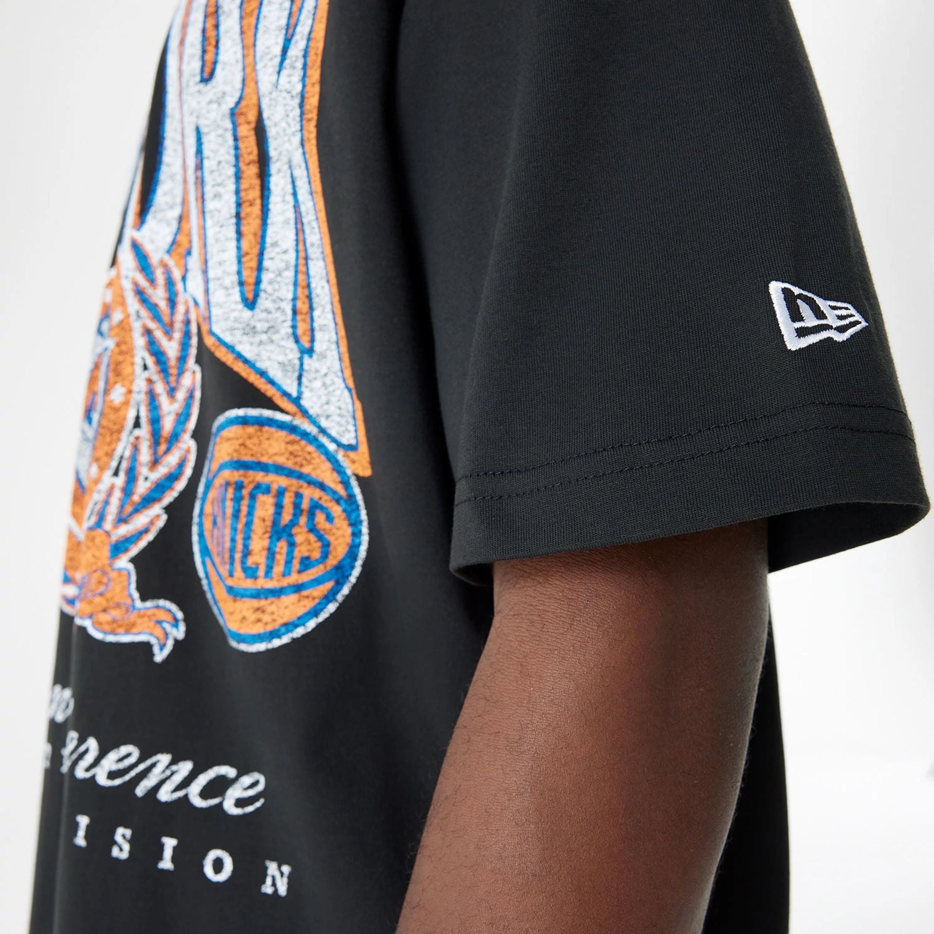 The Male model is wearing New York Knicks Oversized Essential Black Oversized T-Shirt 4