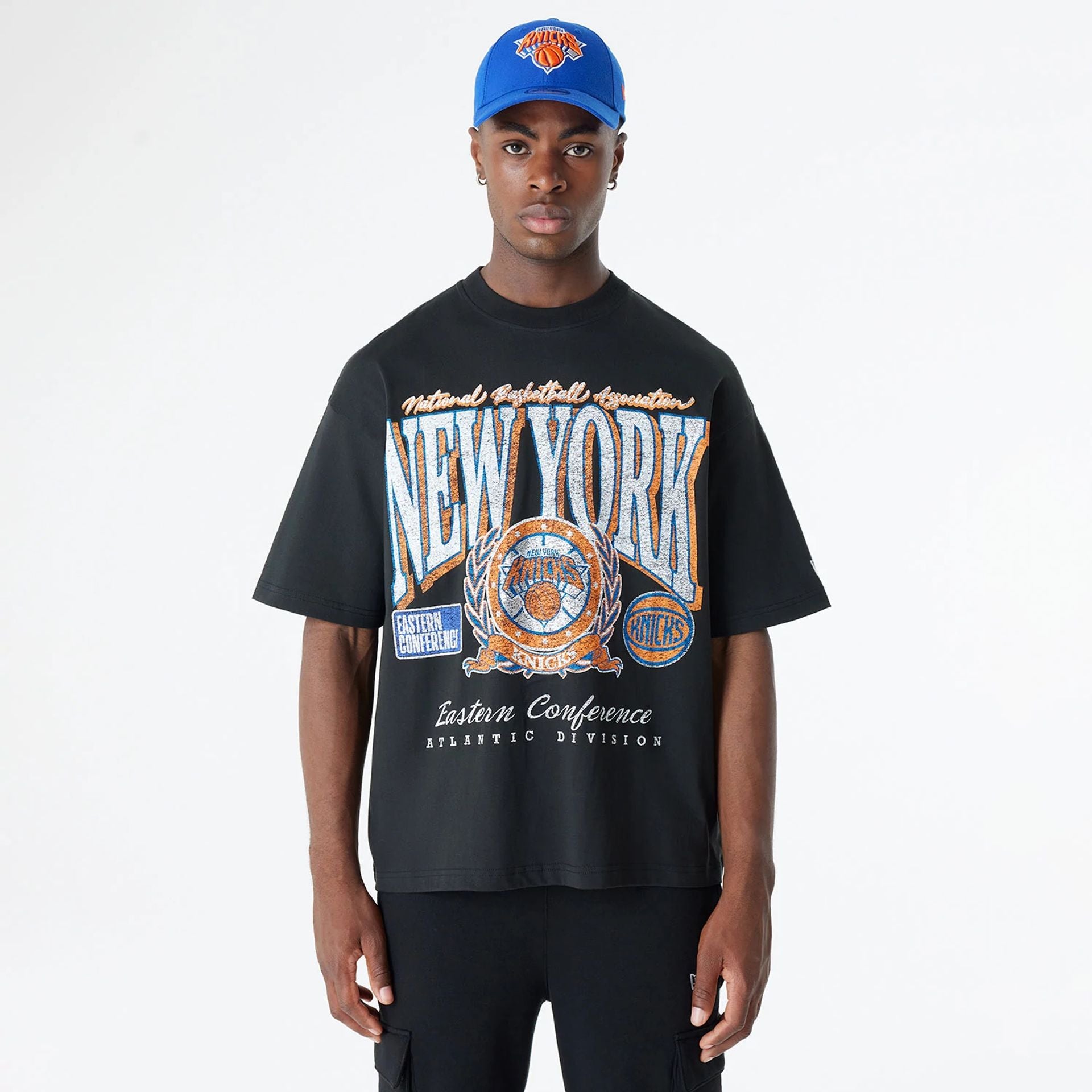 The Male model is wearing New York Knicks Oversized Essential Black Oversized T-Shirt 1