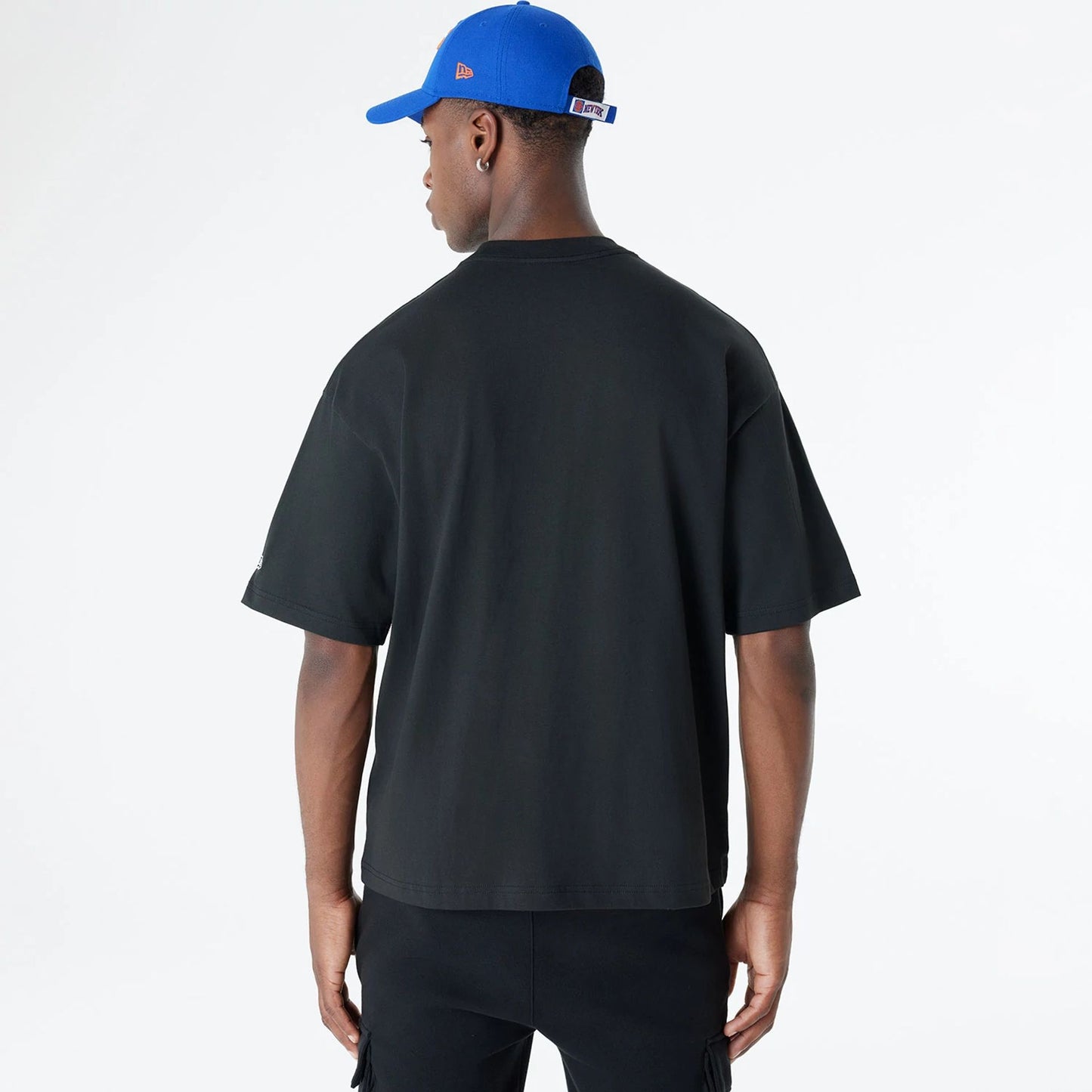 The Male model is wearing New York Knicks Oversized Essential Black Oversized T-Shirt 2