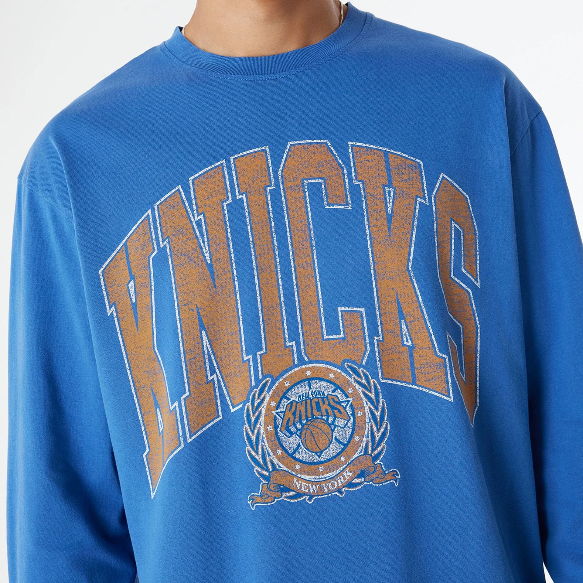 The Male model is wearing New York Knicks Oversized Essential Blue Oversized Long Sleeve T-Shirt 3