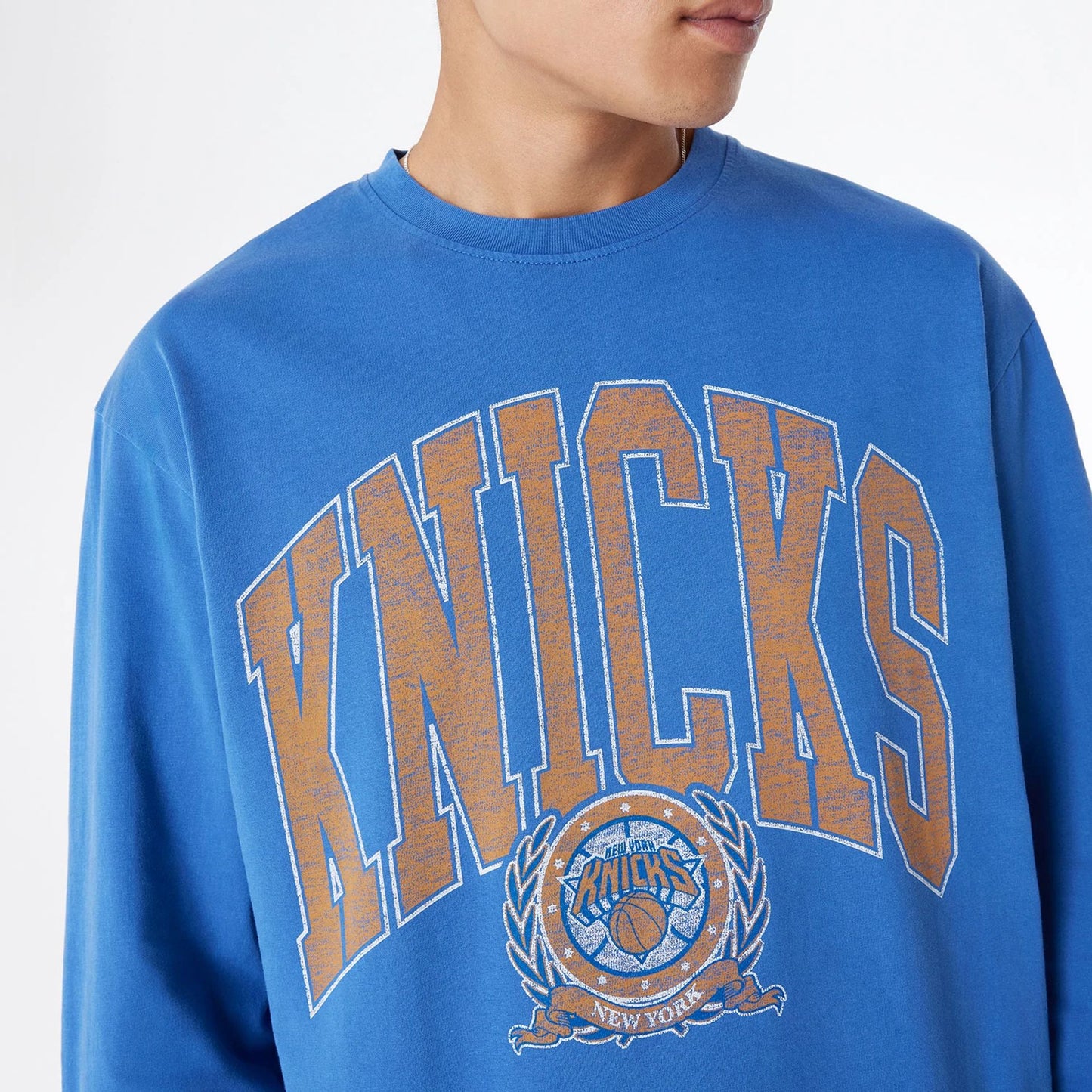 The Male model is wearing New York Knicks Oversized Essential Blue Oversized Long Sleeve T-Shirt 5