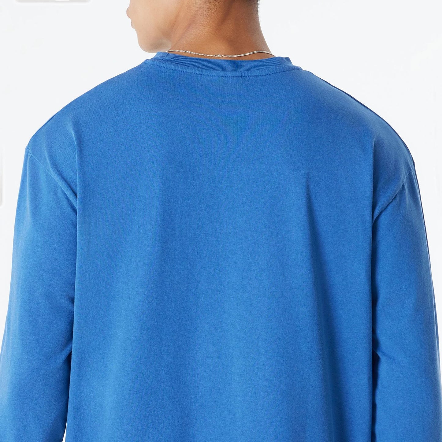 The Male model is wearing New York Knicks Oversized Essential Blue Oversized Long Sleeve T-Shirt 7