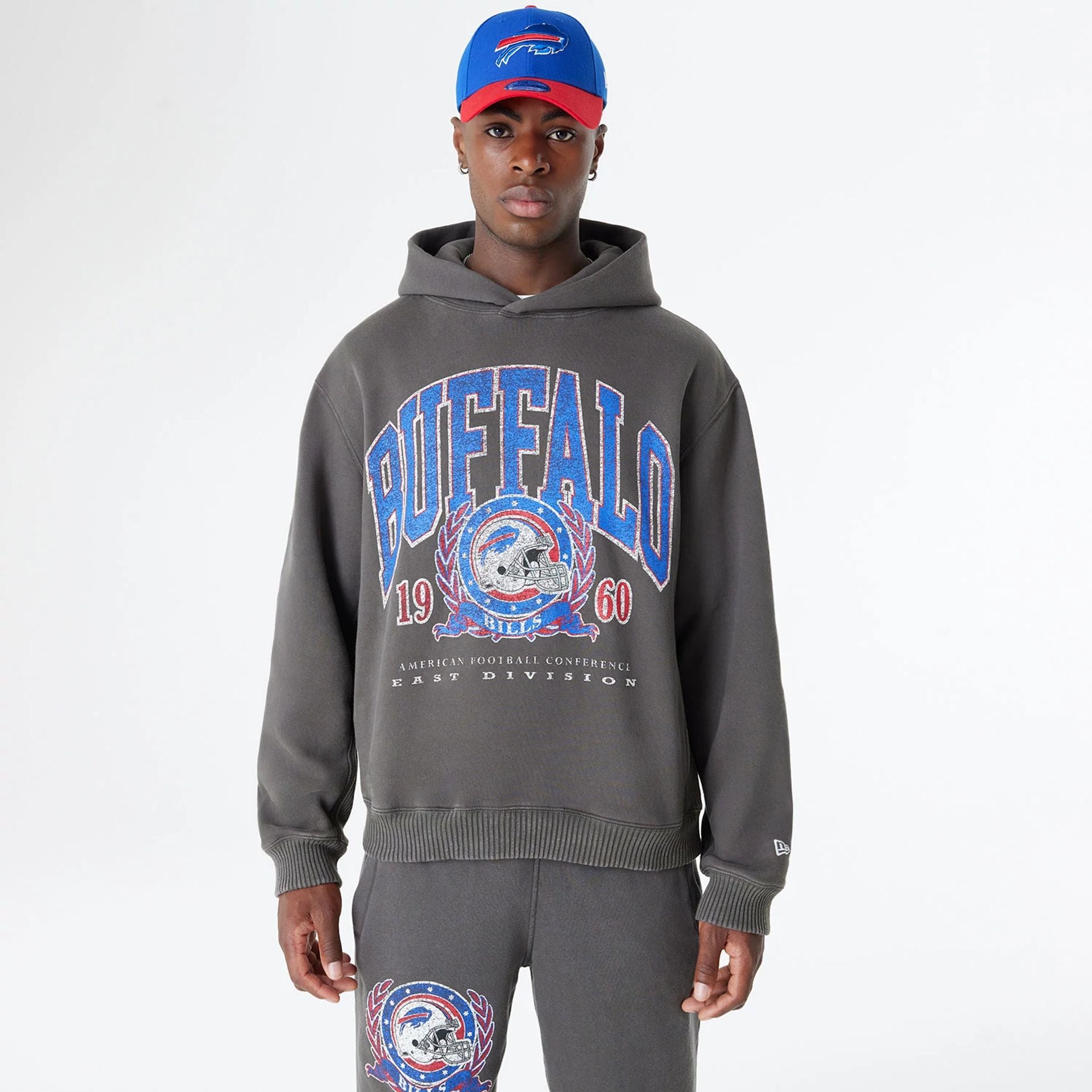 The Male model is wearing Buffalo Bills Oversized Essential Dark Grey Oversized Pullover Hoodie 1