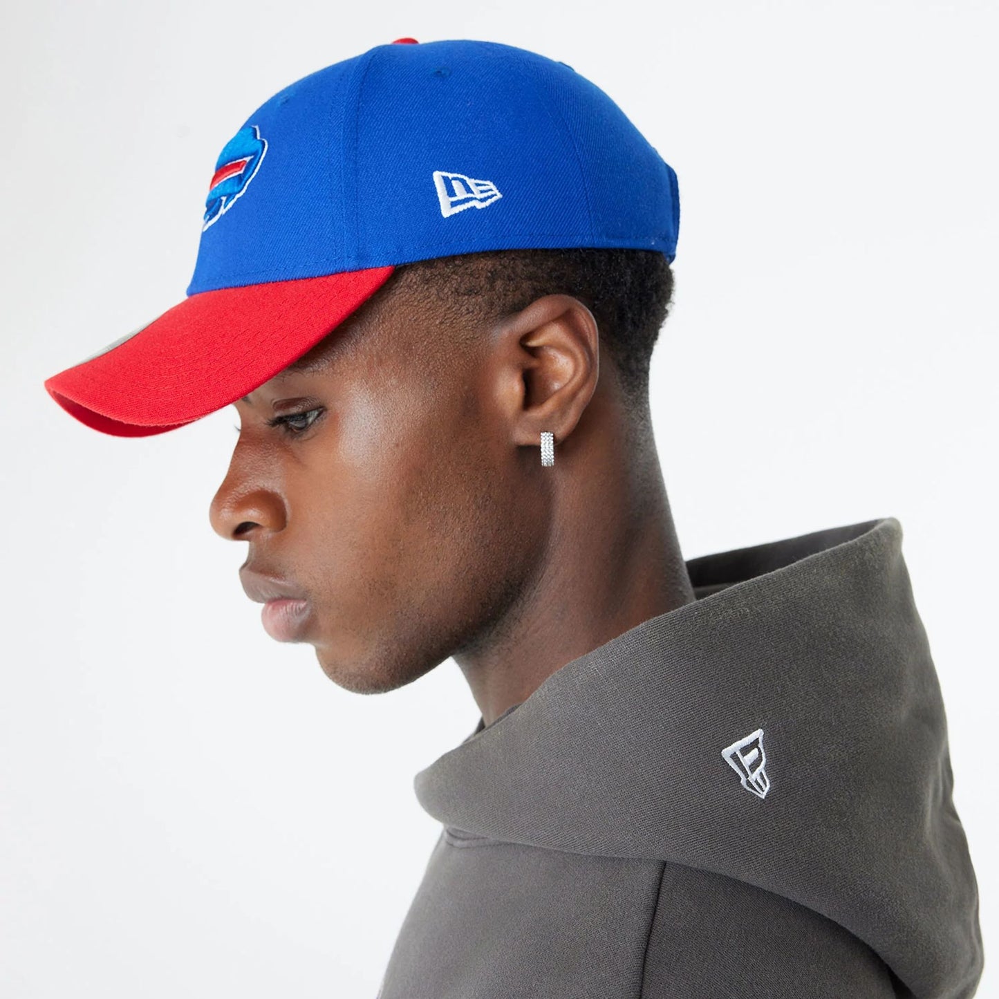 The Male model is wearing Buffalo Bills Oversized Essential Dark Grey Oversized Pullover Hoodie 6