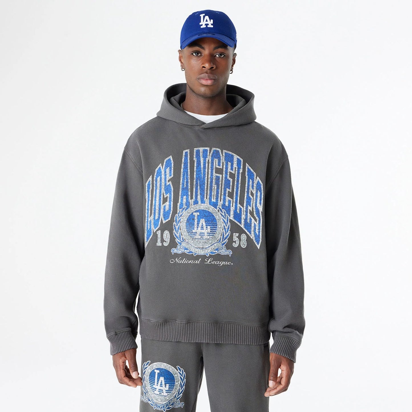 The Male model is wearing LA Dodgers Oversized Essential Dark Grey Oversized Pullover Hoodie 1