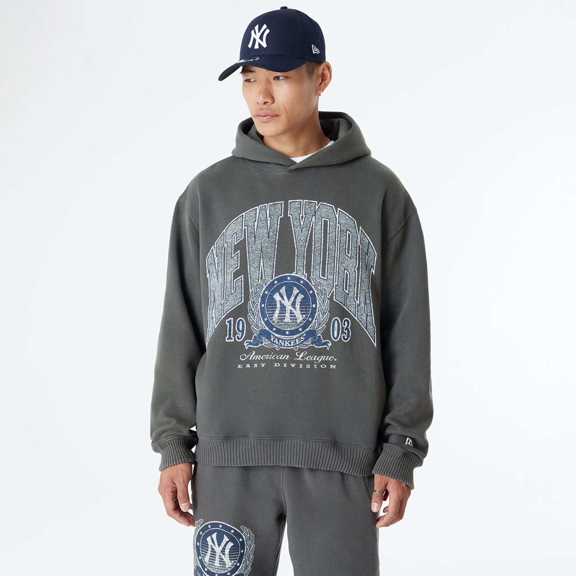 The Male model is wearing New York Yankees Oversized Essential Dark Grey Oversized Pullover Hoodie 1