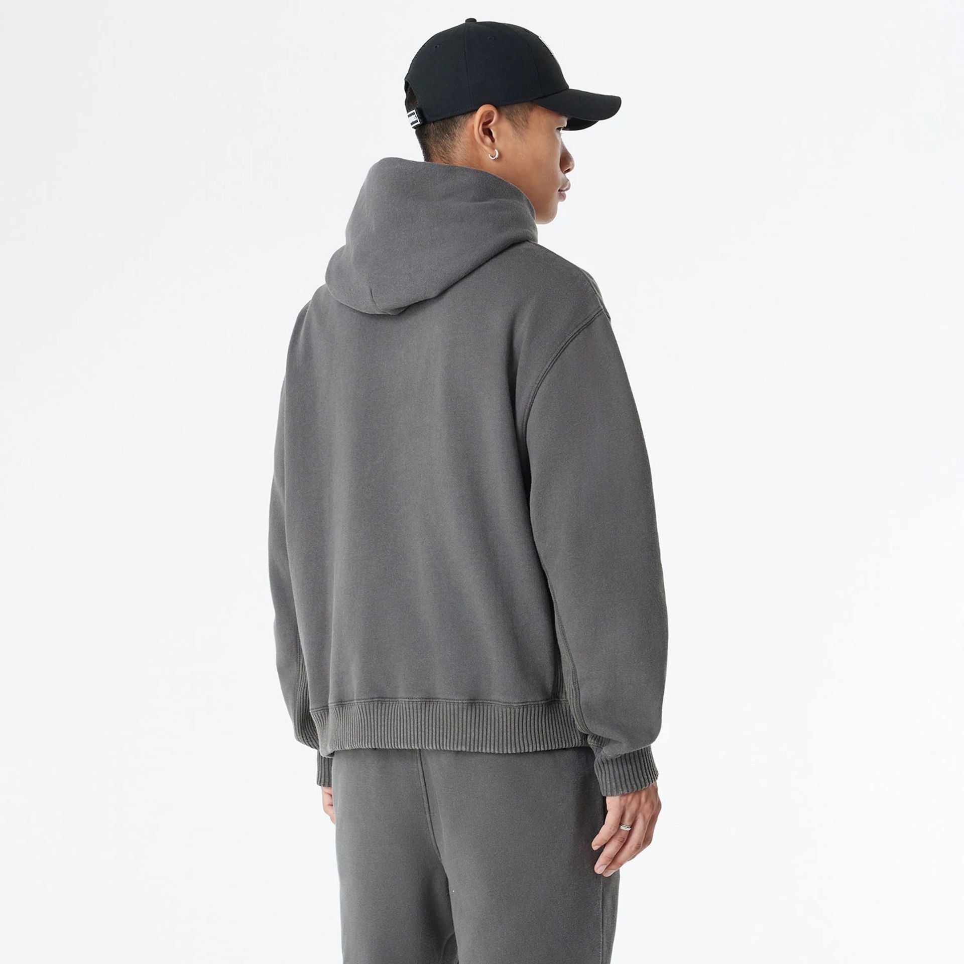 The Male model is wearing Las Vegas Raiders Oversized Essential Dark Grey Oversized Pullover Hoodie 8