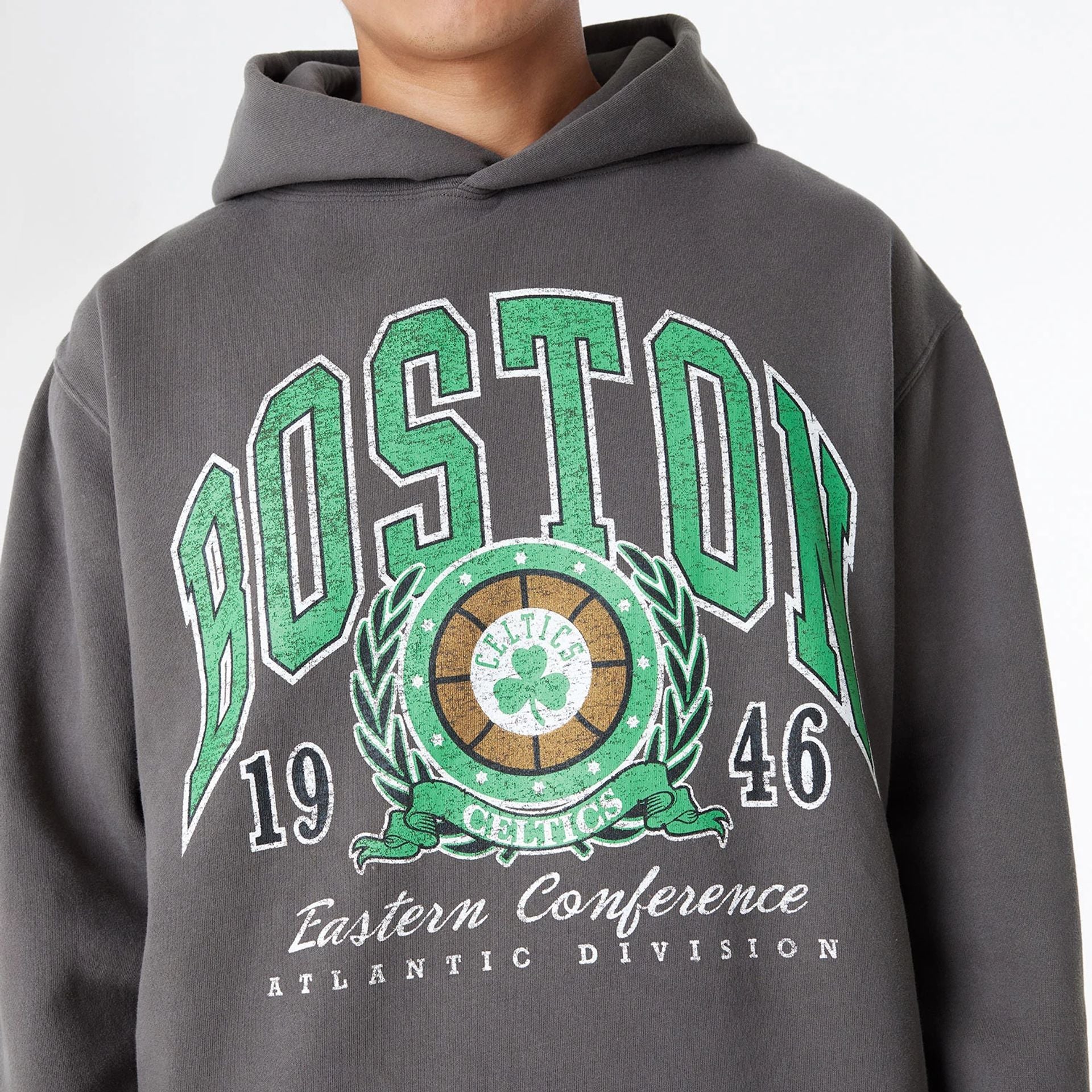 The Male model is wearing Boston Celtics Oversized Essential Dark Grey Oversized Pullover Hoodie 5