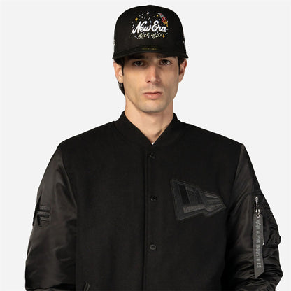 The Male model is wearing New Era x Alpha Industries Black Varsity Jacket 7