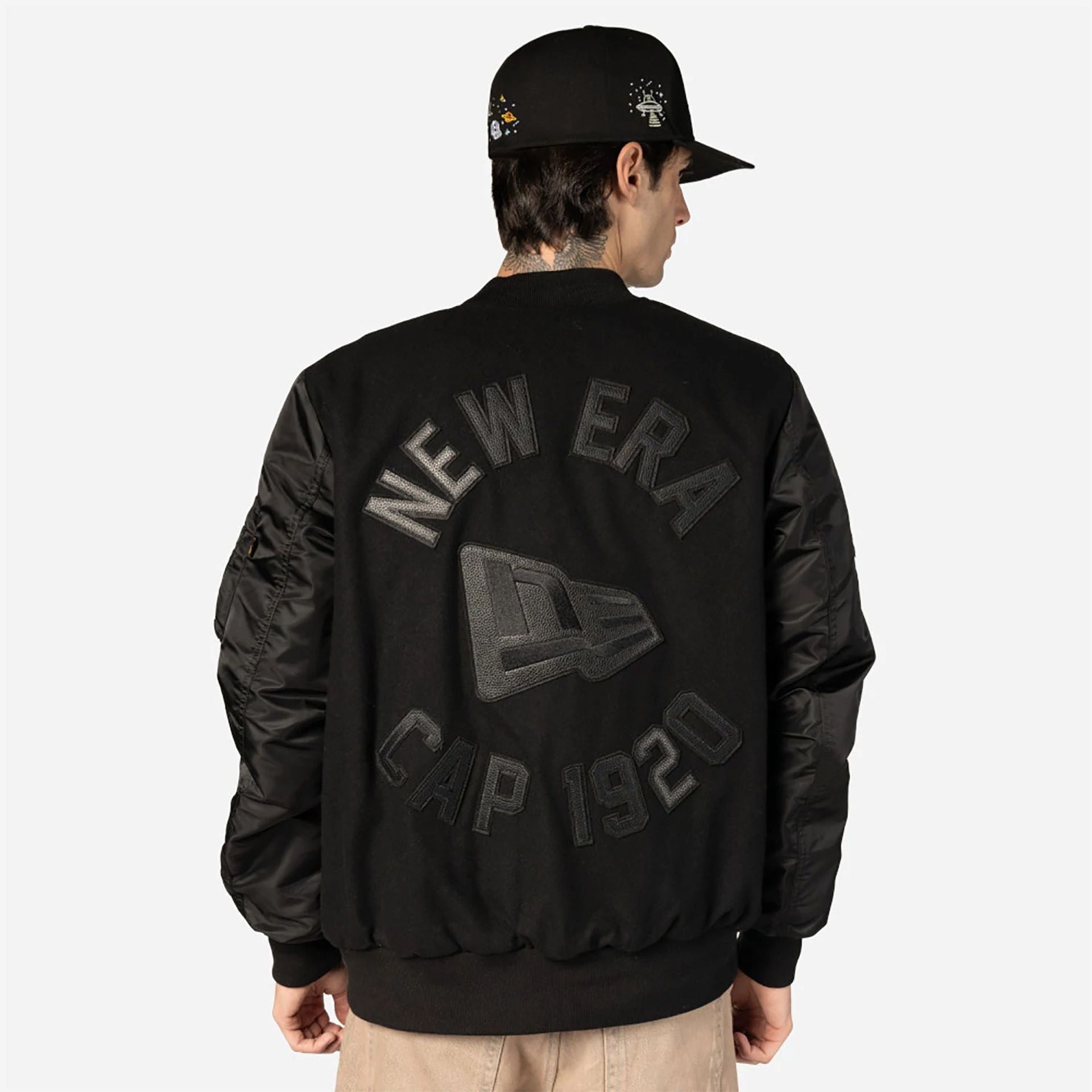 The Male model is wearing New Era x Alpha Industries Black Varsity Jacket 4