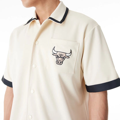 The Male model is wearing Chicago Bulls NBA Lifestyle Revere Light Beige Short Sleeve Shirt 9