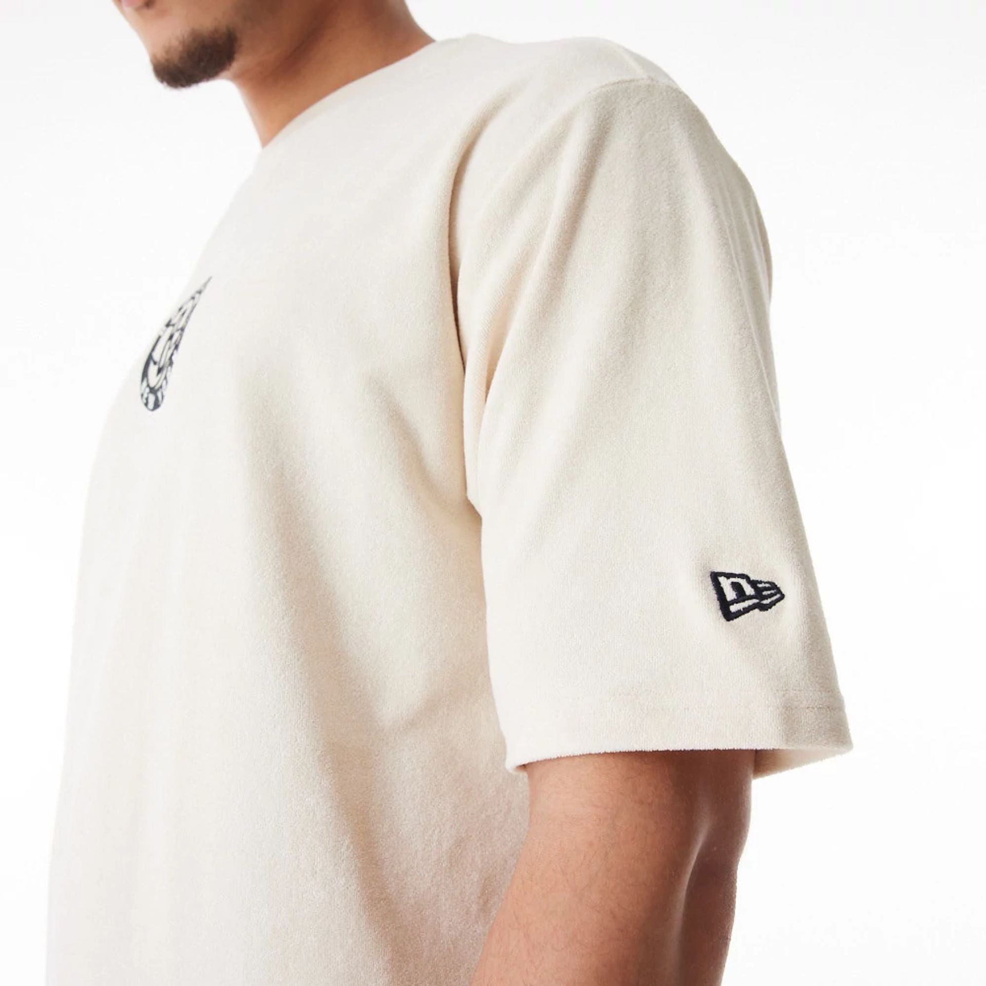 The Male model is wearing Brooklyn Nets NBA Lifestyle Velour Light Beige Oversized T-Shirt  5