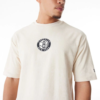 The Male model is wearing Brooklyn Nets NBA Lifestyle Velour Light Beige Oversized T-Shirt  8