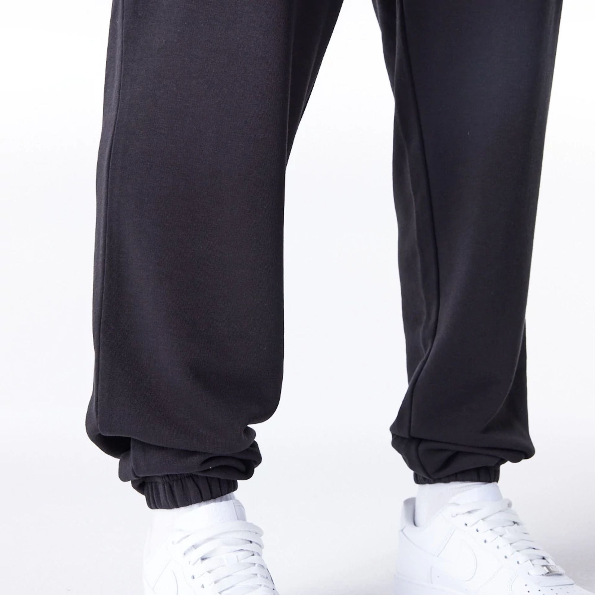 The Male model is wearing Las Vegas Raiders NFL League Essential Black Track Joggers  3