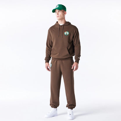 The Male model is wearing Boston Celtics League Essential Dark Brown Oversized Pullover Hoodie  4