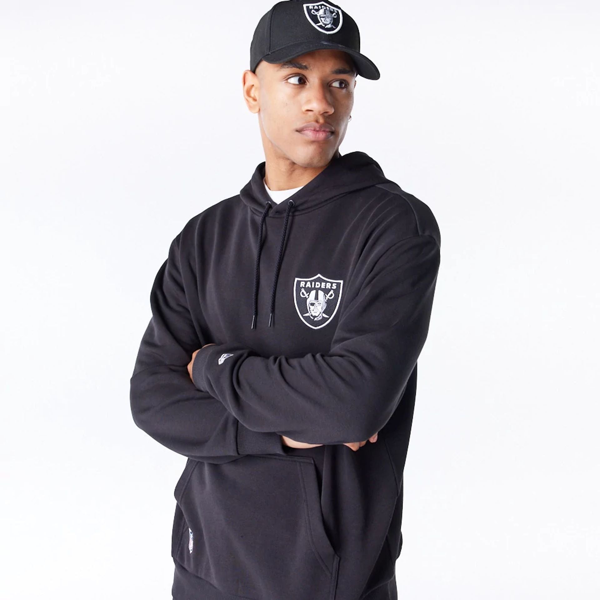 The Male model is wearing Las Vegas Raiders NFL League Essential Black Oversized Pullover Hoodie  1