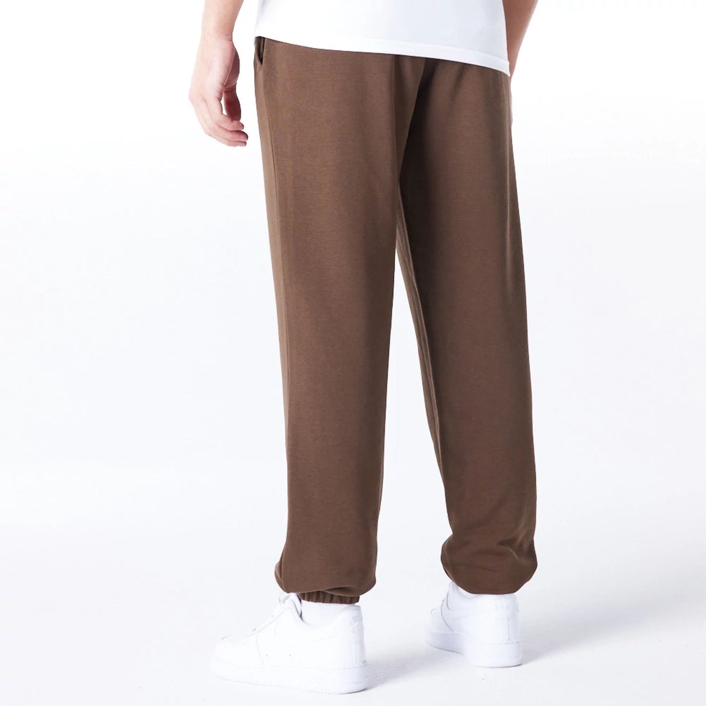 The Male model is wearing Boston Celtics League Essential Dark Brown Track Joggers  3