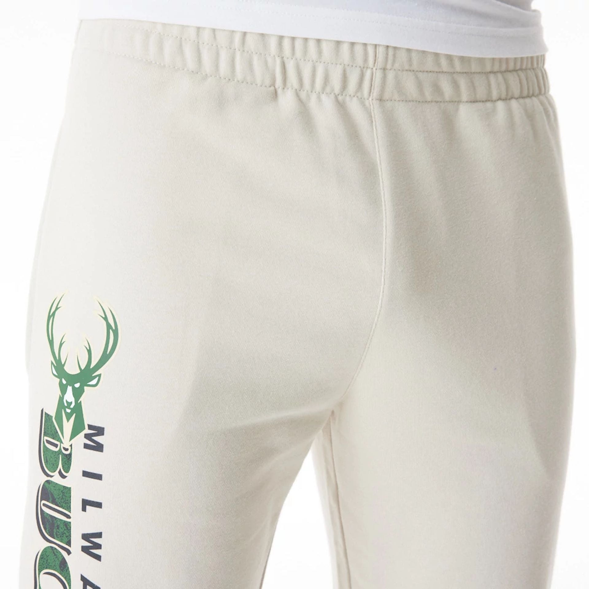 The Male model is wearing Milwaukee Bucks NBA Graphic Cream Joggers  7