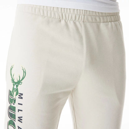 The Male model is wearing Milwaukee Bucks NBA Graphic Cream Joggers  7