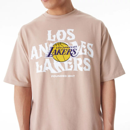 The Male model is wearing LA Lakers NBA Graphic Beige Oversized T-Shirt  5