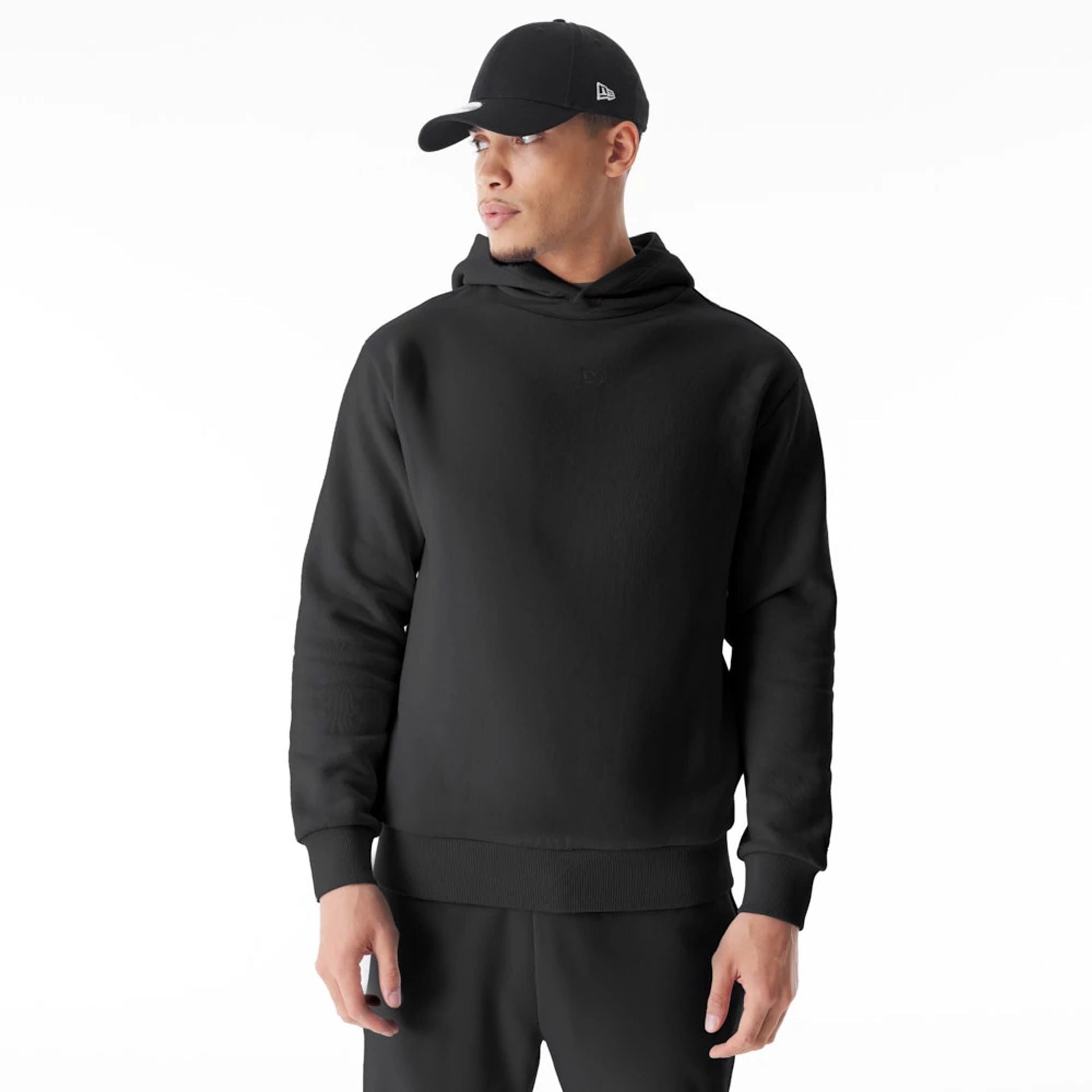 The Male model is wearing  New Era Flag Black Oversized Pullover Hoodie  1