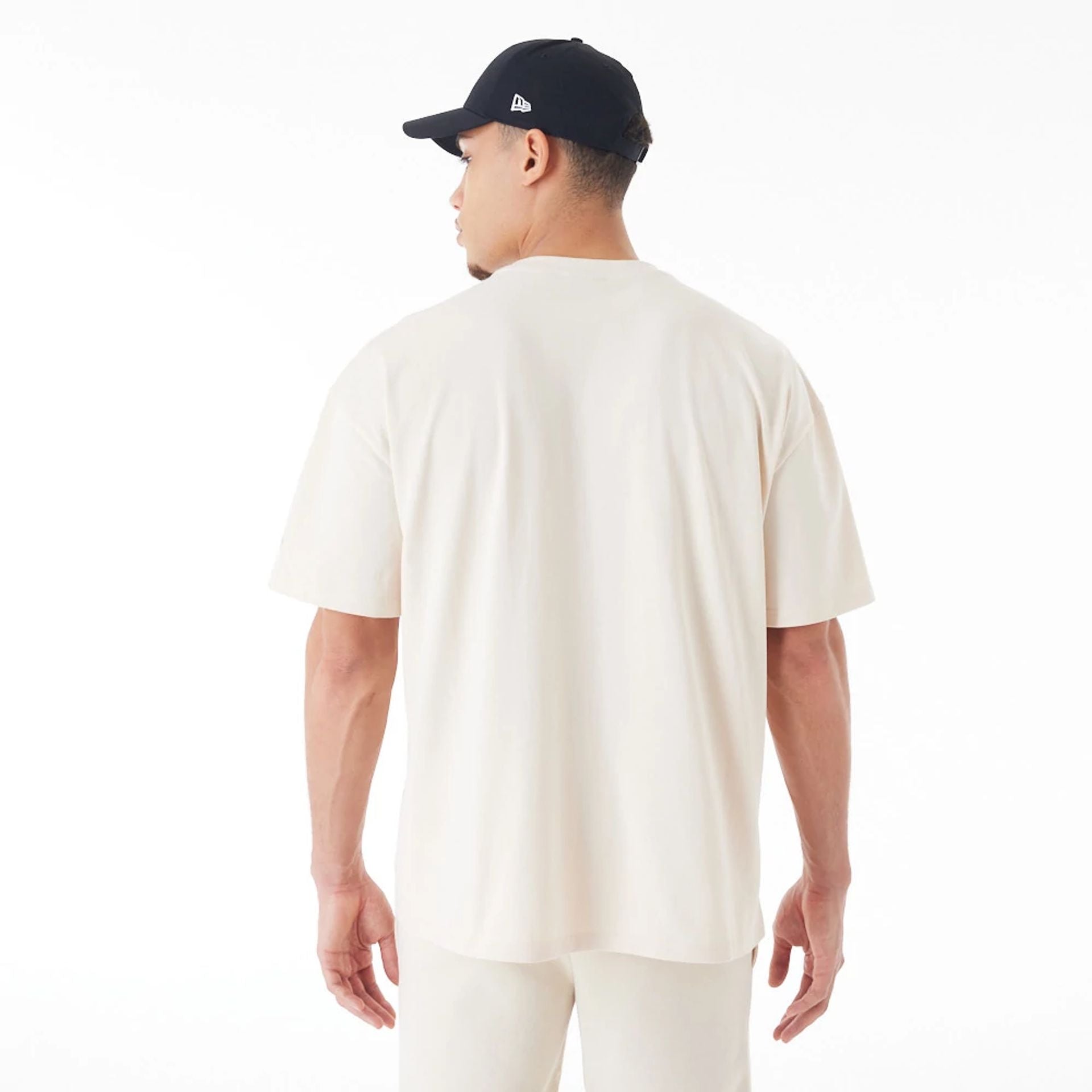 The Male model is wearing  New Era Flag Cream Oversized T-Shirt  2