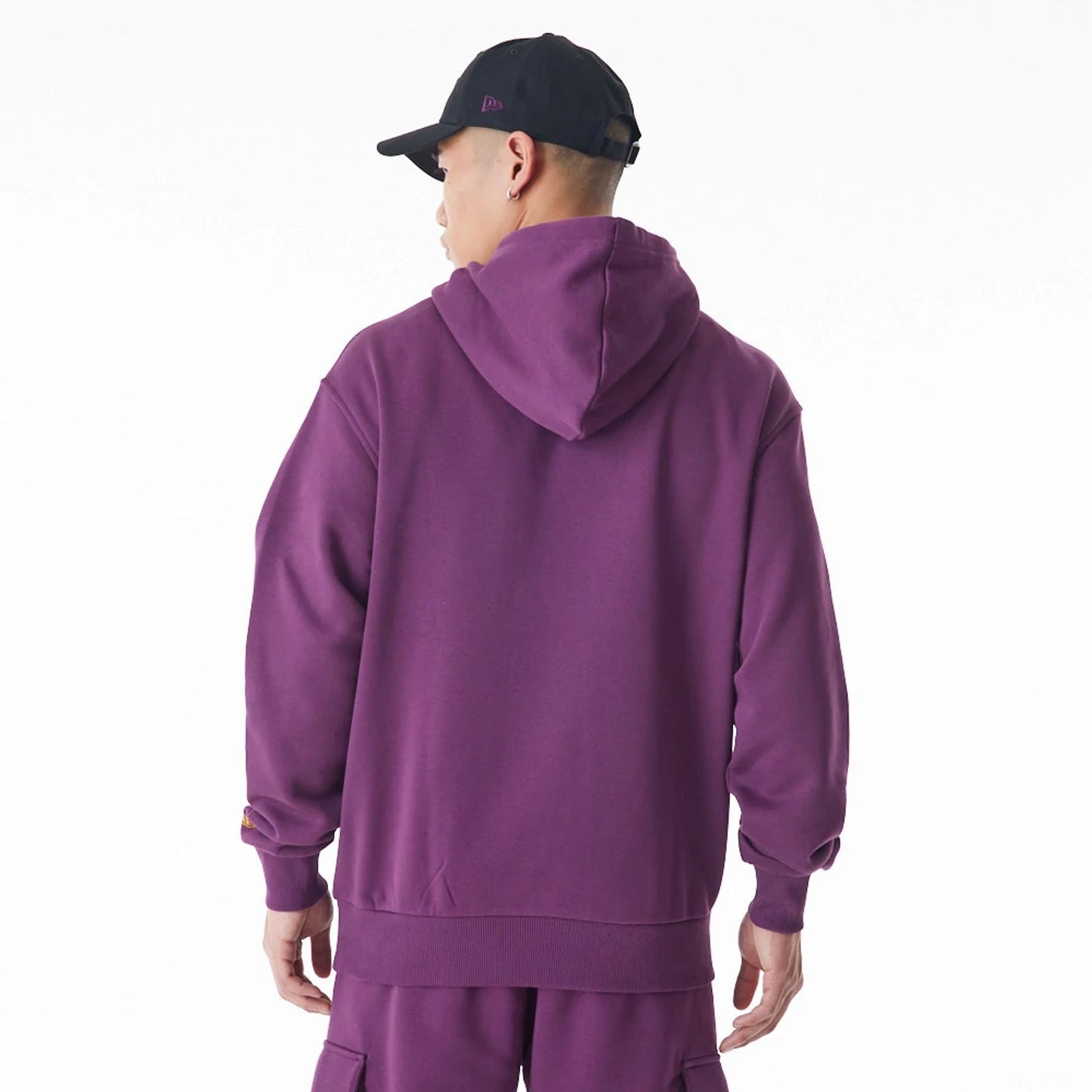 The Male model is wearing  New Era Script Logo Dark Purple Oversized Pullover Hoodie  10