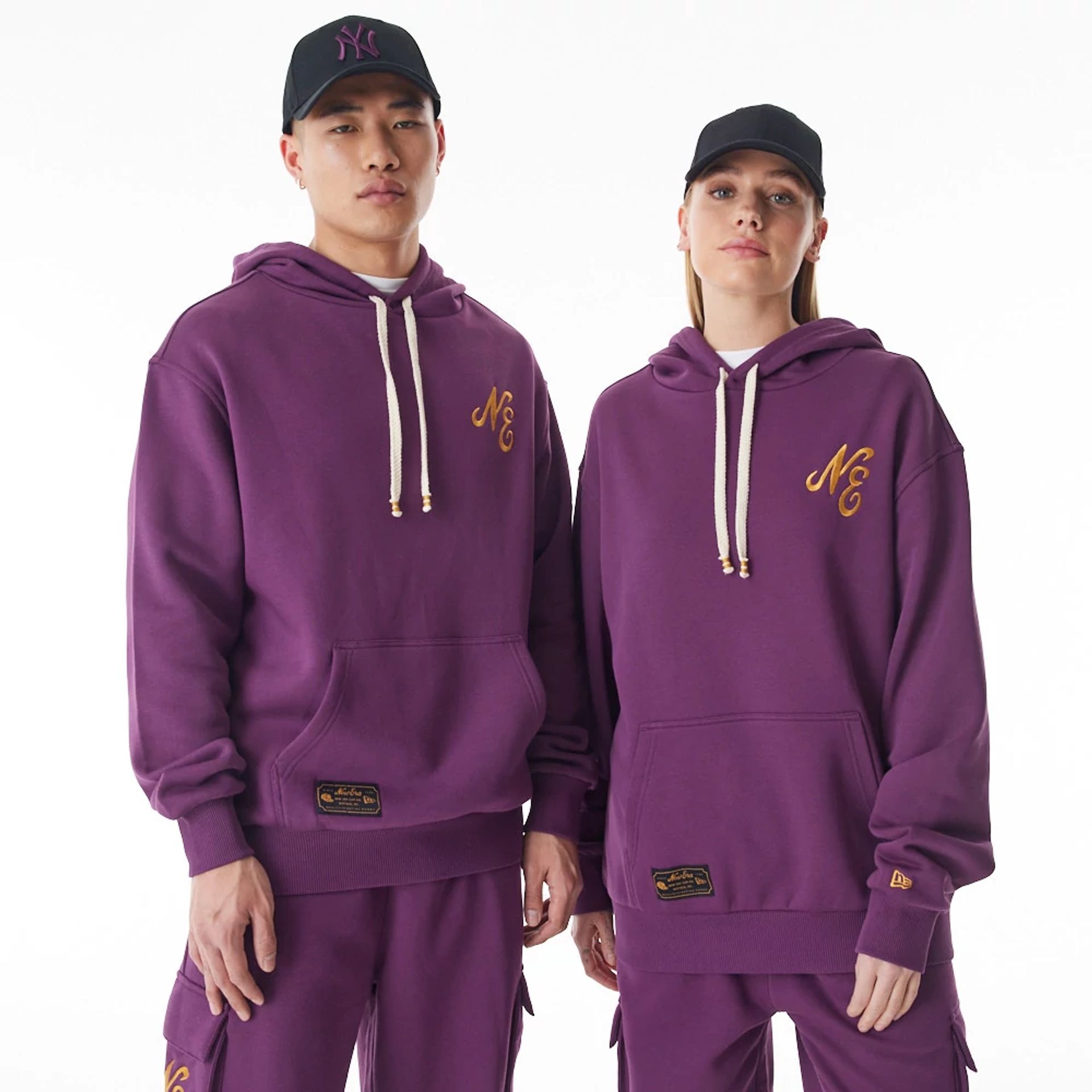 The Male model is wearing  New Era Script Logo Dark Purple Oversized Pullover Hoodie  1