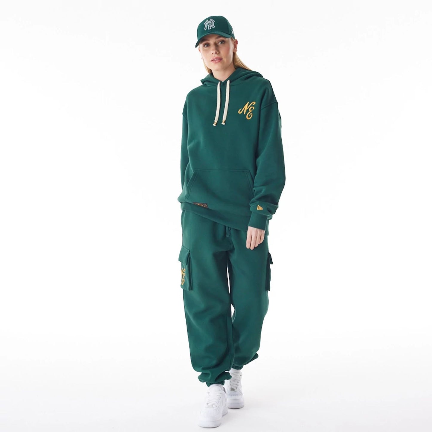 The Male model is wearing  New Era Script Logo Dark Green Oversized Pullover Hoodie  6