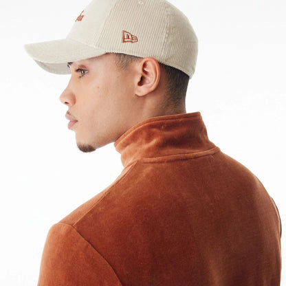 The Male model is wearing  New Era Velour Brown Track Jacket  9